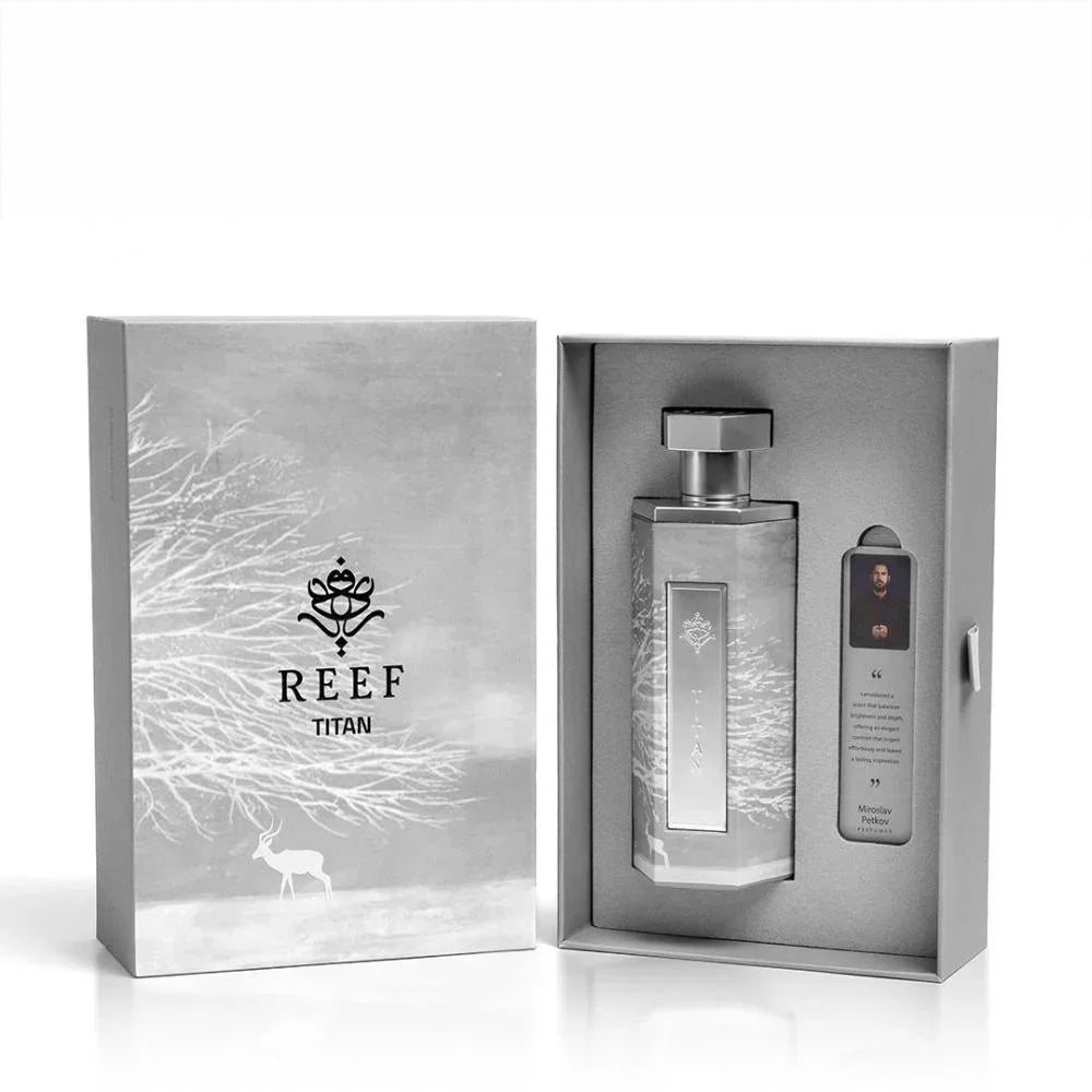 REEF Titan perfume bottle in elegant silver packaging with winter-themed design and deer motif