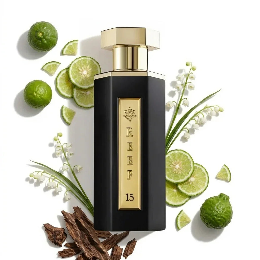 REEF 15 perfume bottle with lime slices, white flowers, and oud wood accents