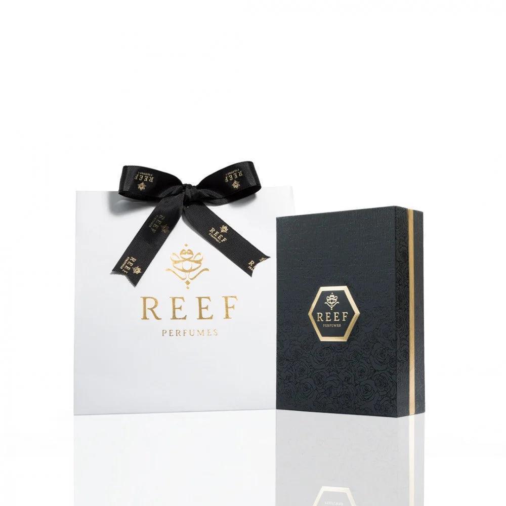 REEF Perfumes gift set with luxury white bag and black box, elegant gold branding for premium fragrance