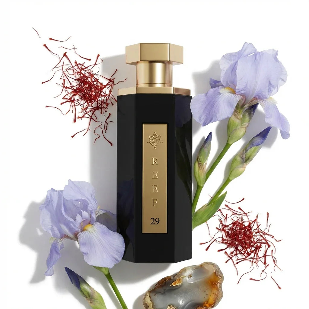 Luxury black perfume bottle with gold cap, purple iris flowers, and saffron threads, evoking Oriental fragrance notes.