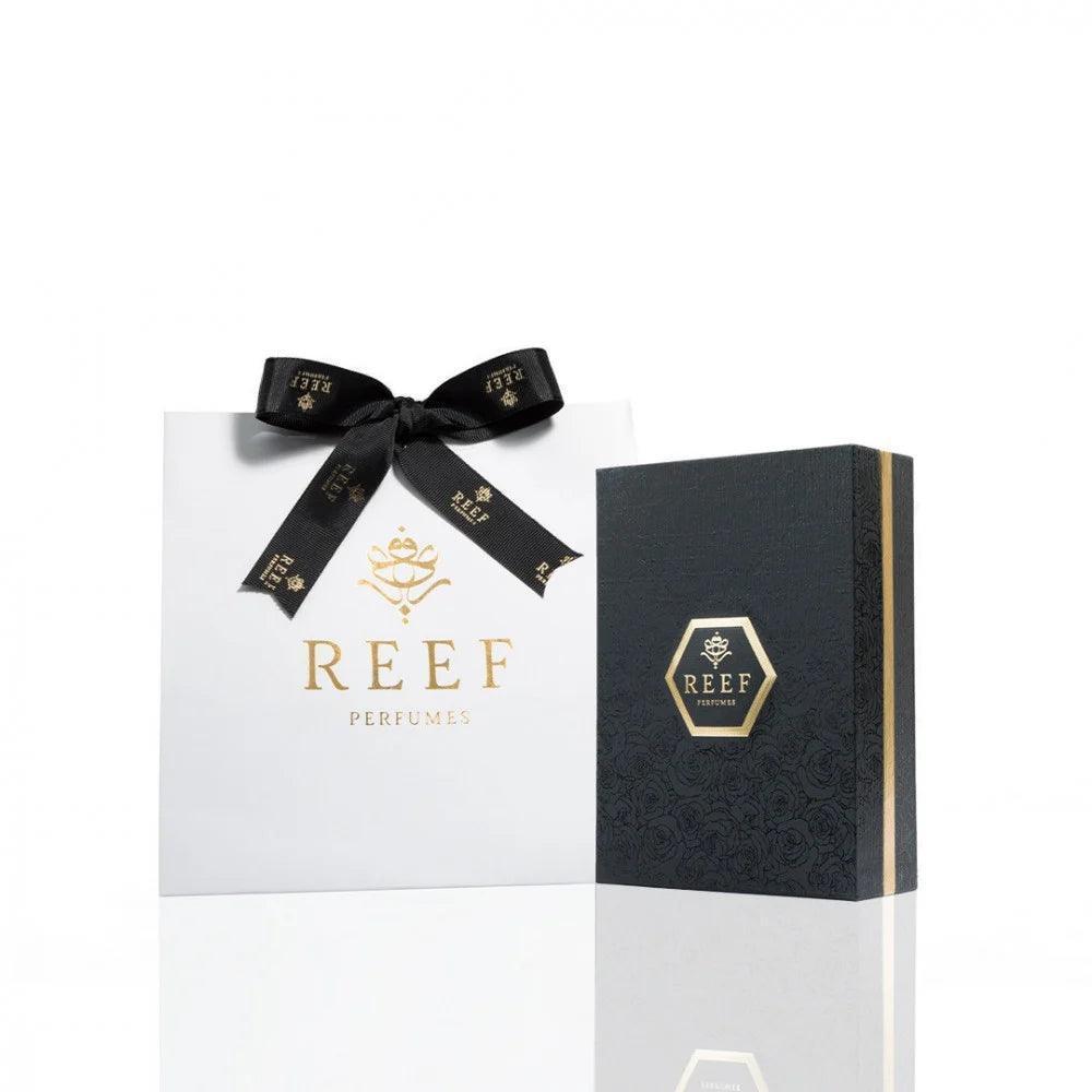 REEF Perfumes luxury gift set with elegant white bag and black box, gold accents, and branded ribbon