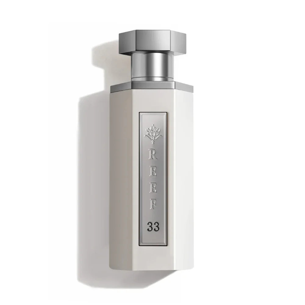 REEF 33 luxury perfume bottle with silver cap and elegant white design