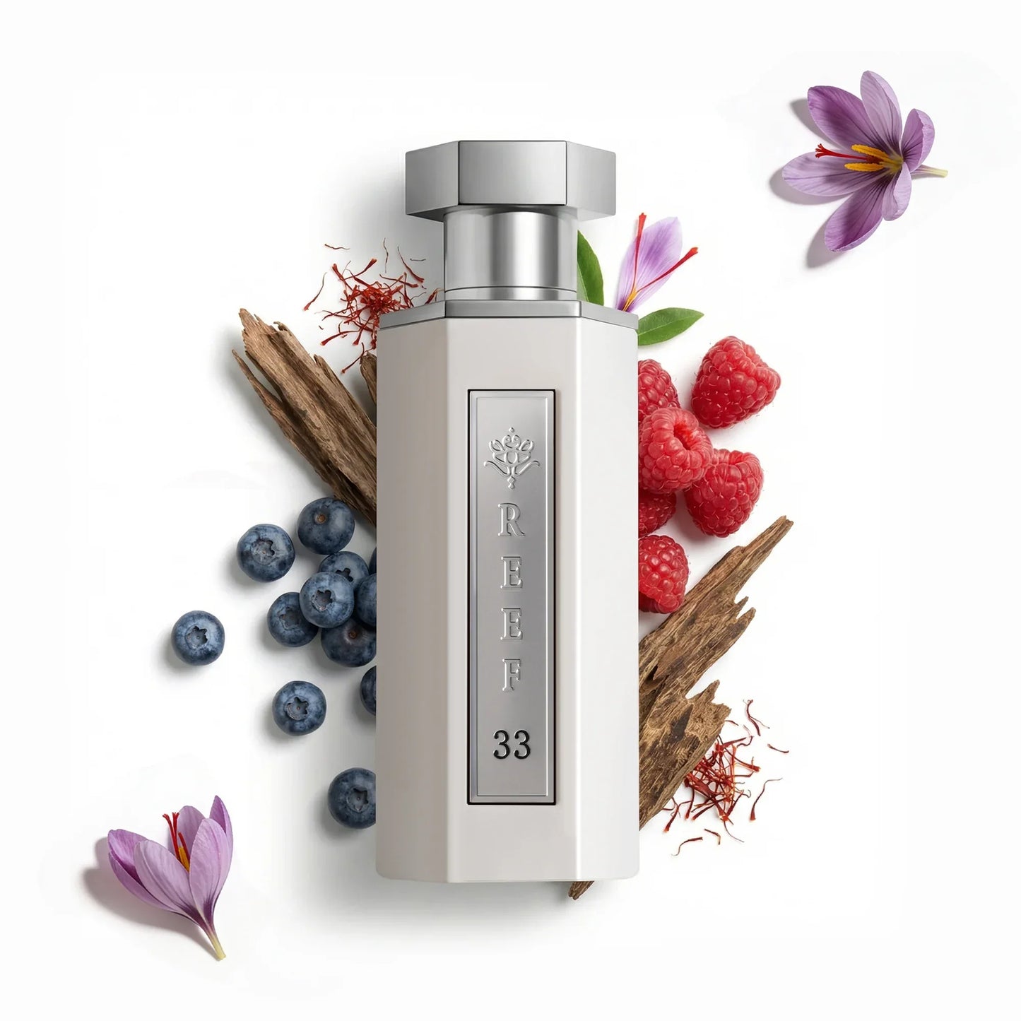 REEF 33 perfume bottle with saffron, raspberries, blueberries, and floral accents