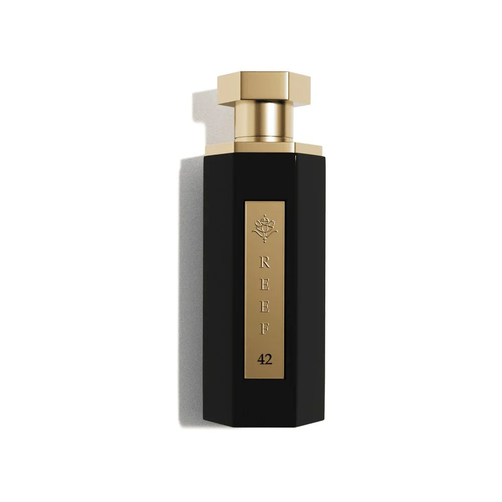 Elegant black perfume bottle with gold accents, labeled REEF 42, evoking luxury and oriental fragrance notes