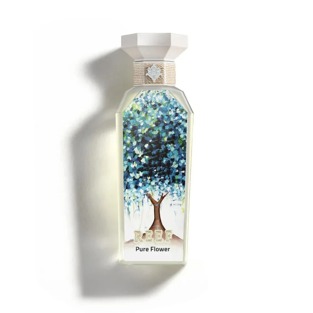 REEF Pure Flower perfume bottle with floral tree design, evoking Arabian garden essence